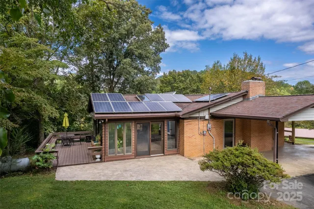 a patio with hardwood table and chairs