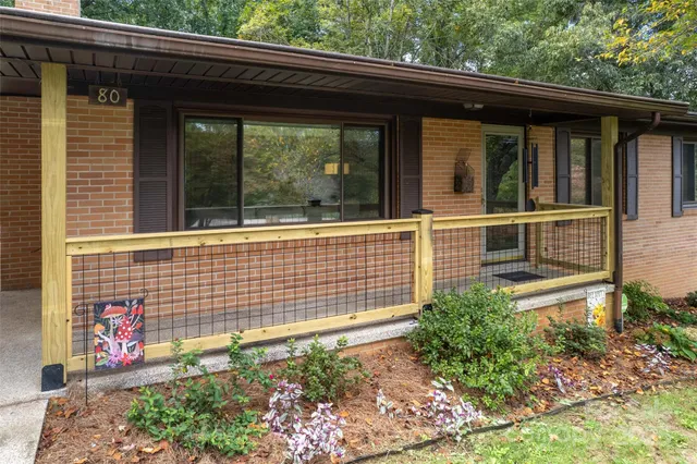 a side view of a house with a garden