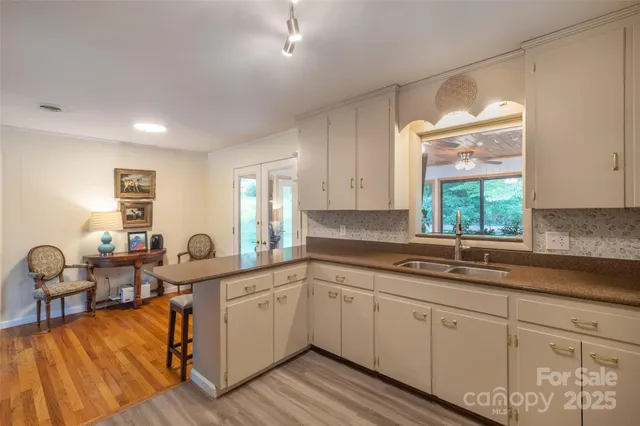 a kitchen with a sink cabinets and window