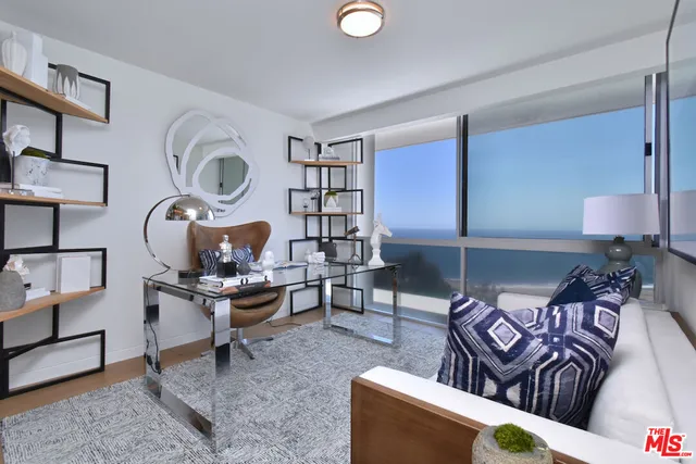 a living room with furniture a rug and white walls