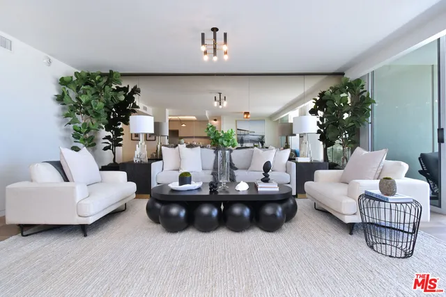 a living room with furniture and a potted plant