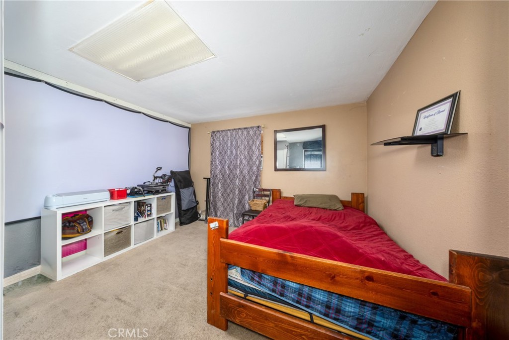 566 South Sage Avenue Rialto, CA 92376 - Photo 23 of 28 a bedroom with a bed and a window