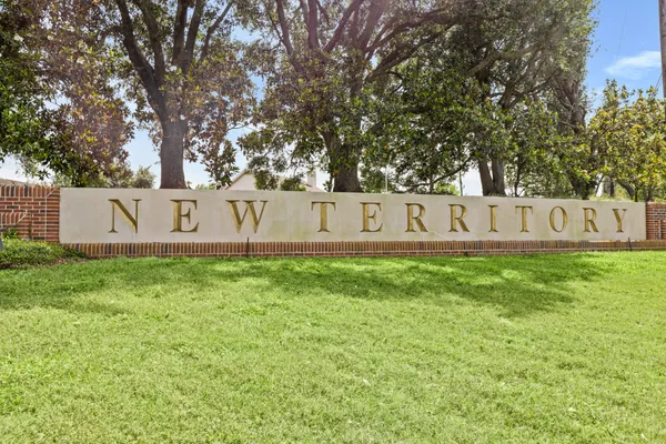 a view of garden with tree in the background