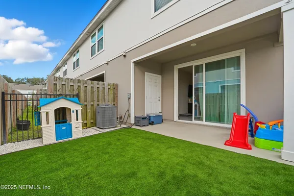 a large kitchen with granite countertop a sink a stove a refrigerator and a granite counter top