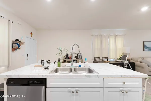 a living room with furniture large window and flat screen tv