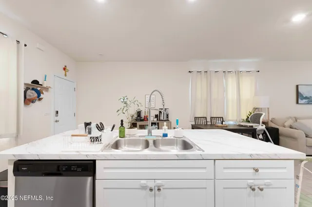 a living room with furniture large window and flat screen tv