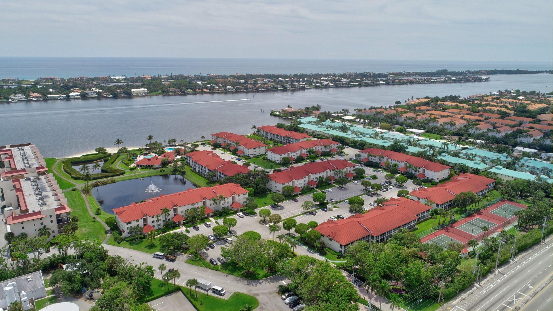an aerial view of lake and residential houses with outdoor space