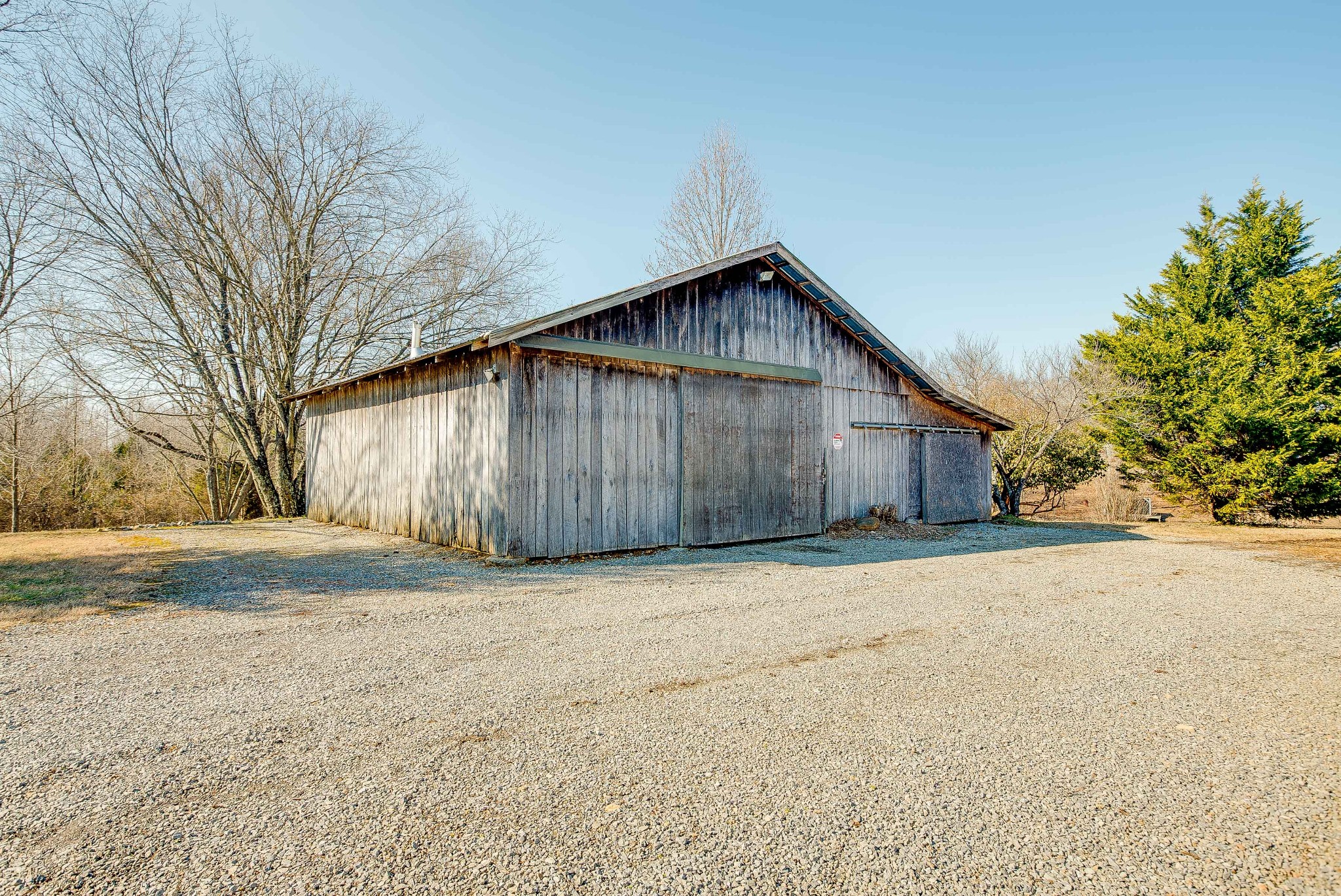 513 Lee Road Cottontown, TN 37048 - Photo 54 of 55 a wooden bench sitting in middle of a field