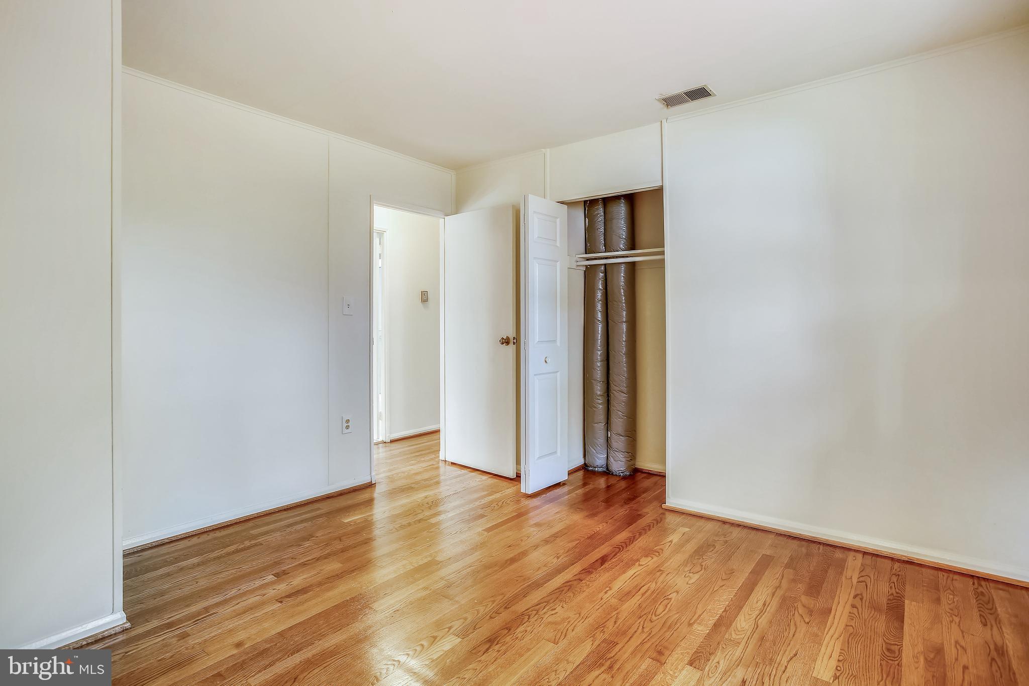 10216 Rodgers Road Fairfax, VA 22030 - Photo 11 of 20 an empty room with wooden floor and closet