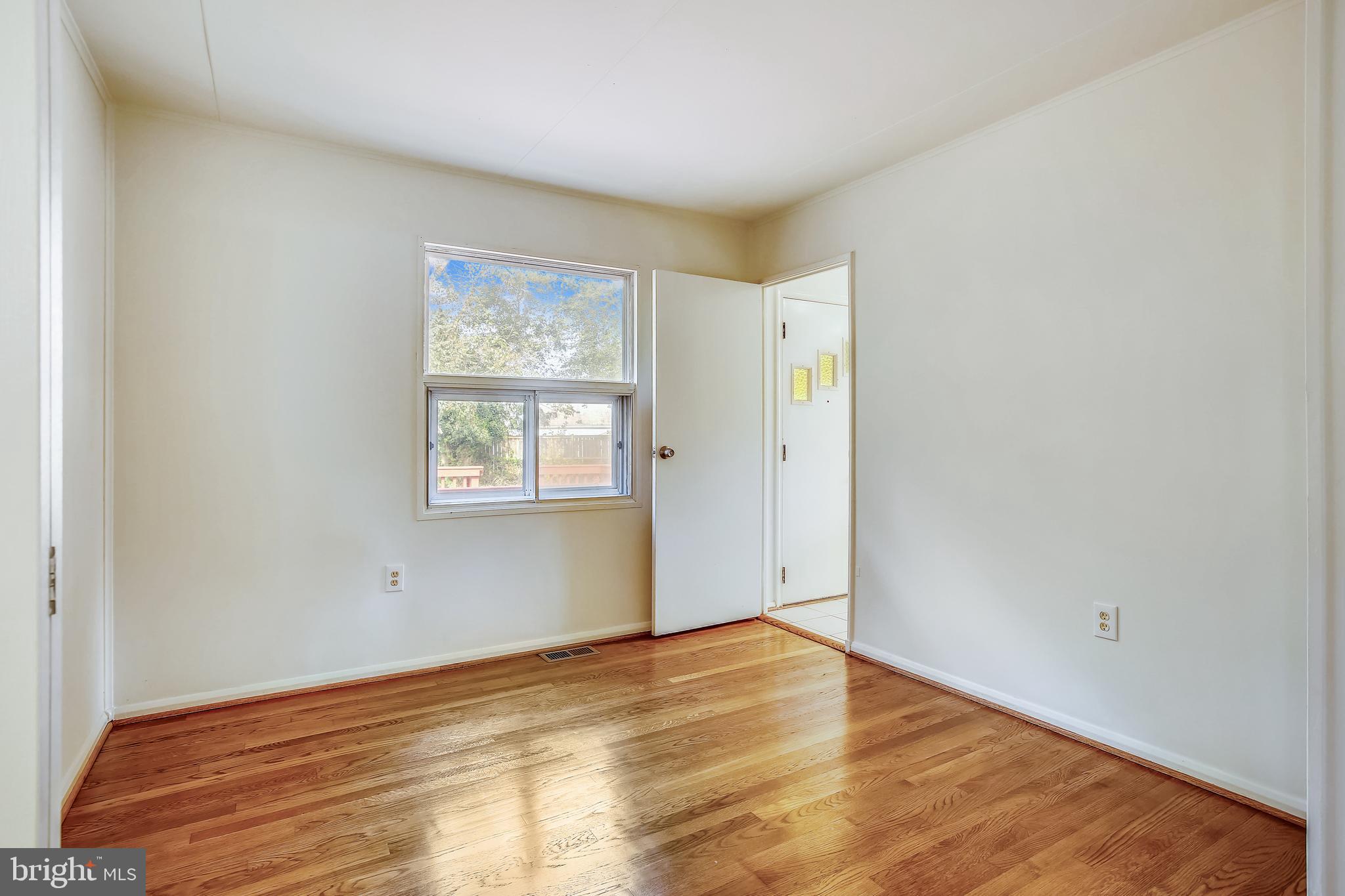 10216 Rodgers Road Fairfax, VA 22030 - Photo 12 of 20 a view of empty room with wooden floor and fan