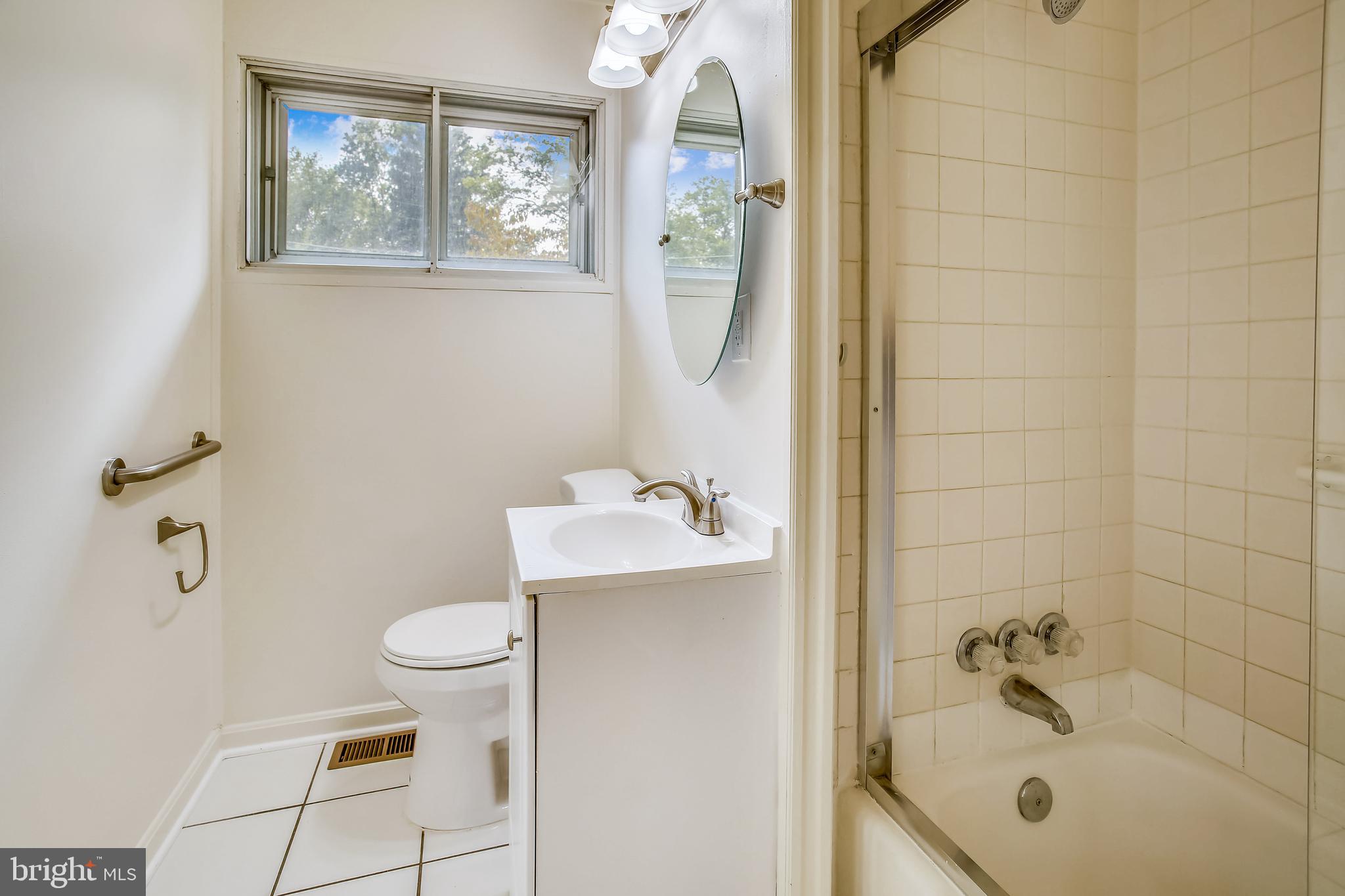 10216 Rodgers Road Fairfax, VA 22030 - Photo 14 of 20 a bathroom with a sink a toilet and shower