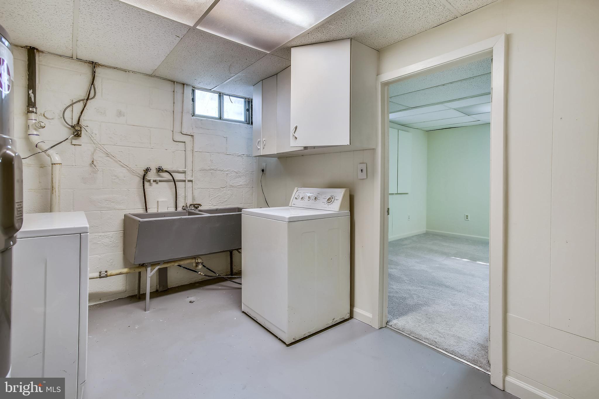 10216 Rodgers Road Fairfax, VA 22030 - Photo 20 of 20 a utility room with cabinets washer and dryer