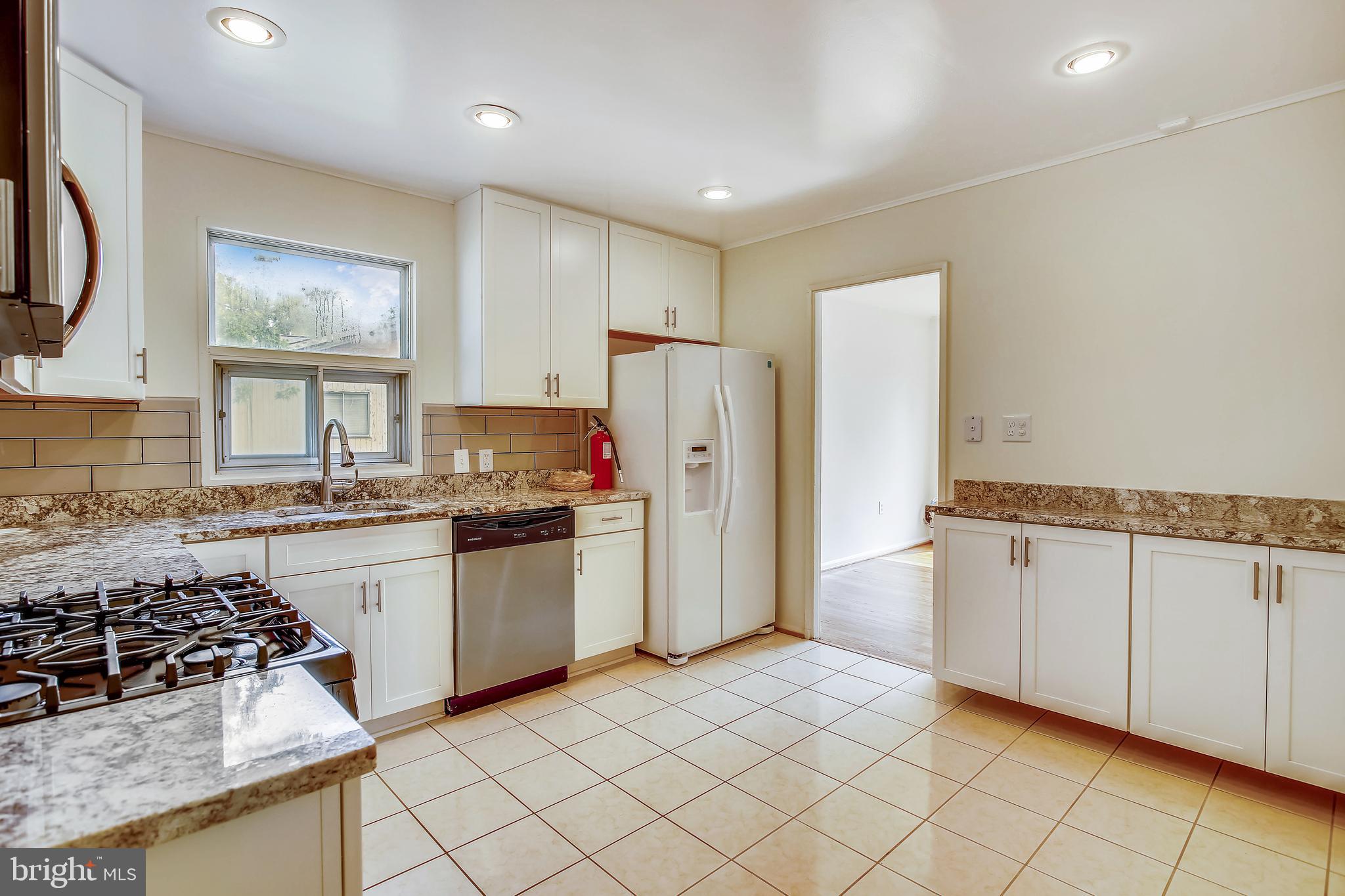 10216 Rodgers Road Fairfax, VA 22030 - Photo 6 of 20 a kitchen with a stove a sink and a refrigerator