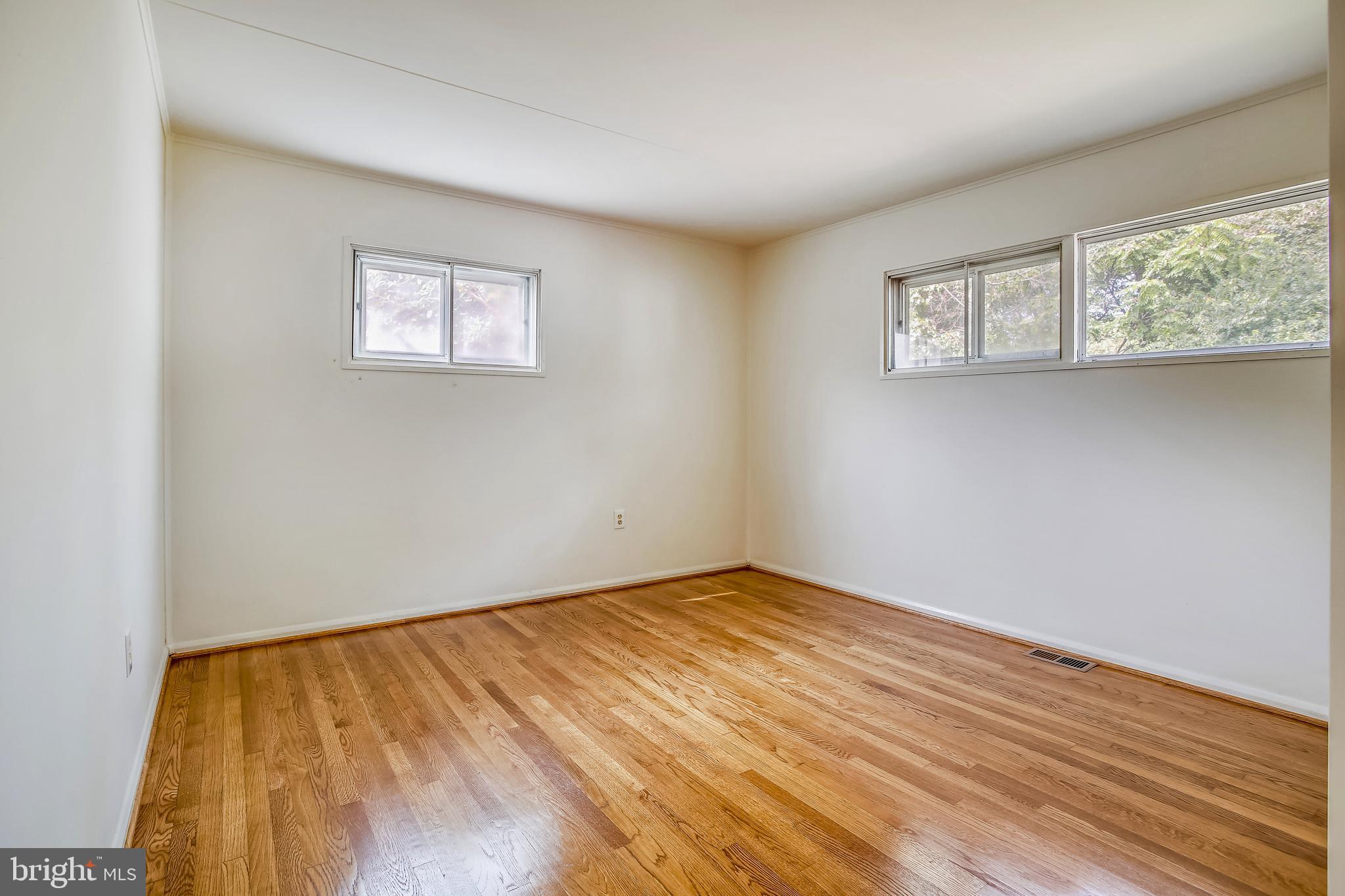 10216 Rodgers Road Fairfax, VA 22030 - Photo 9 of 20 a view of an empty room with wooden floor and a window