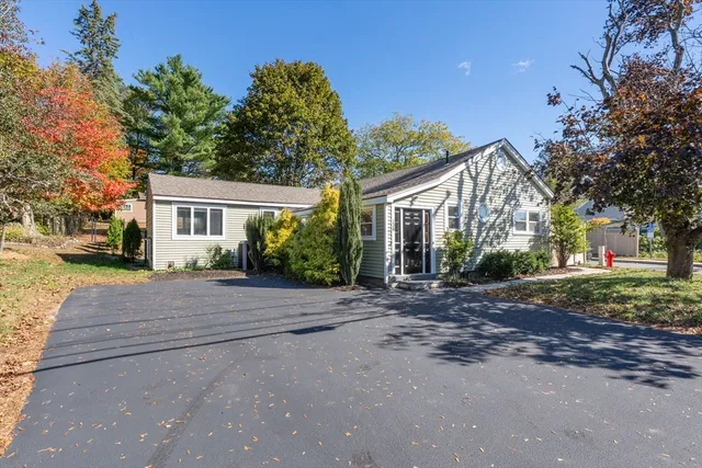 a view of a house with a yard and street