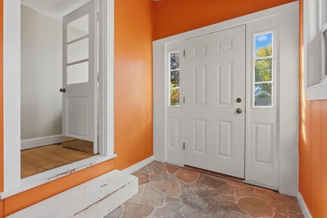 a kitchen with granite countertop a refrigerator and a stove top oven