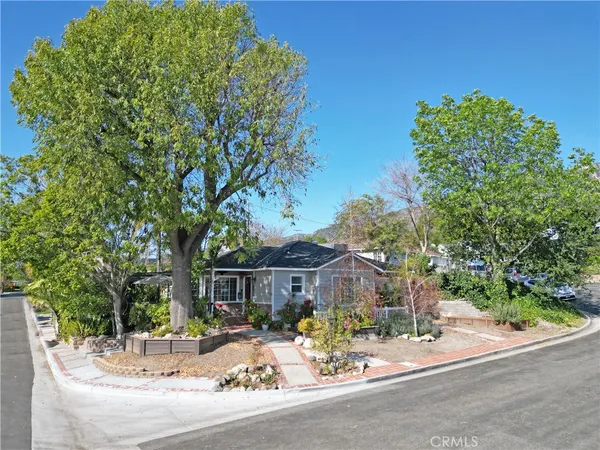 a view of a house with a tree in the background