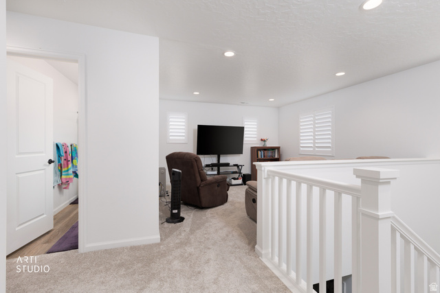 540 Lefty Lane Tooele, UT 84074 - Photo 15 of 48 Hallway featuring an upstairs landing, light colored carpet, and recessed lighting