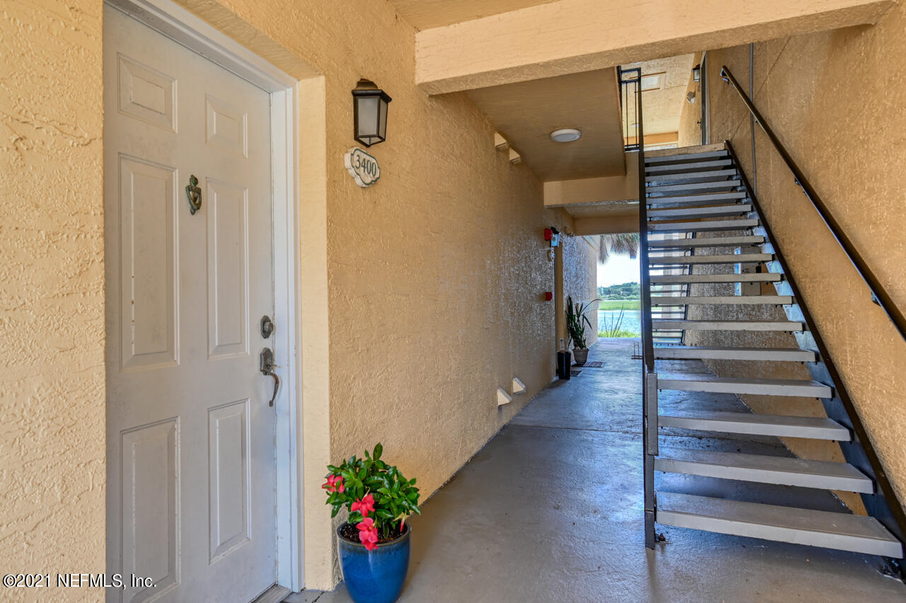 3400 Haley Pointe Road St. Augustine, FL 32084 - Photo 3 of 41 a view of a hallway with wooden floor and stairs