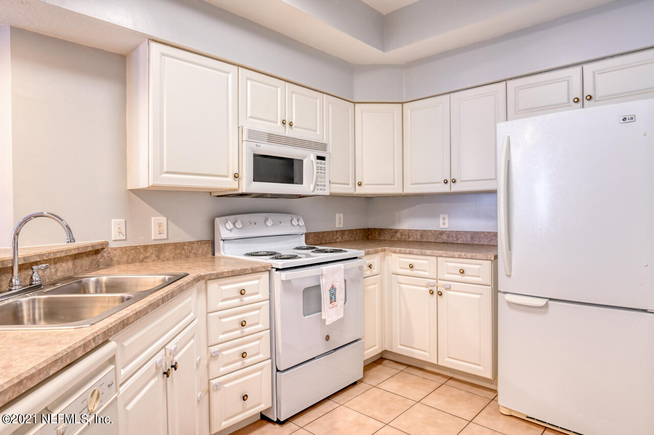 3400 Haley Pointe Road St. Augustine, FL 32084 - Photo 4 of 41 a kitchen with white cabinets and white appliances