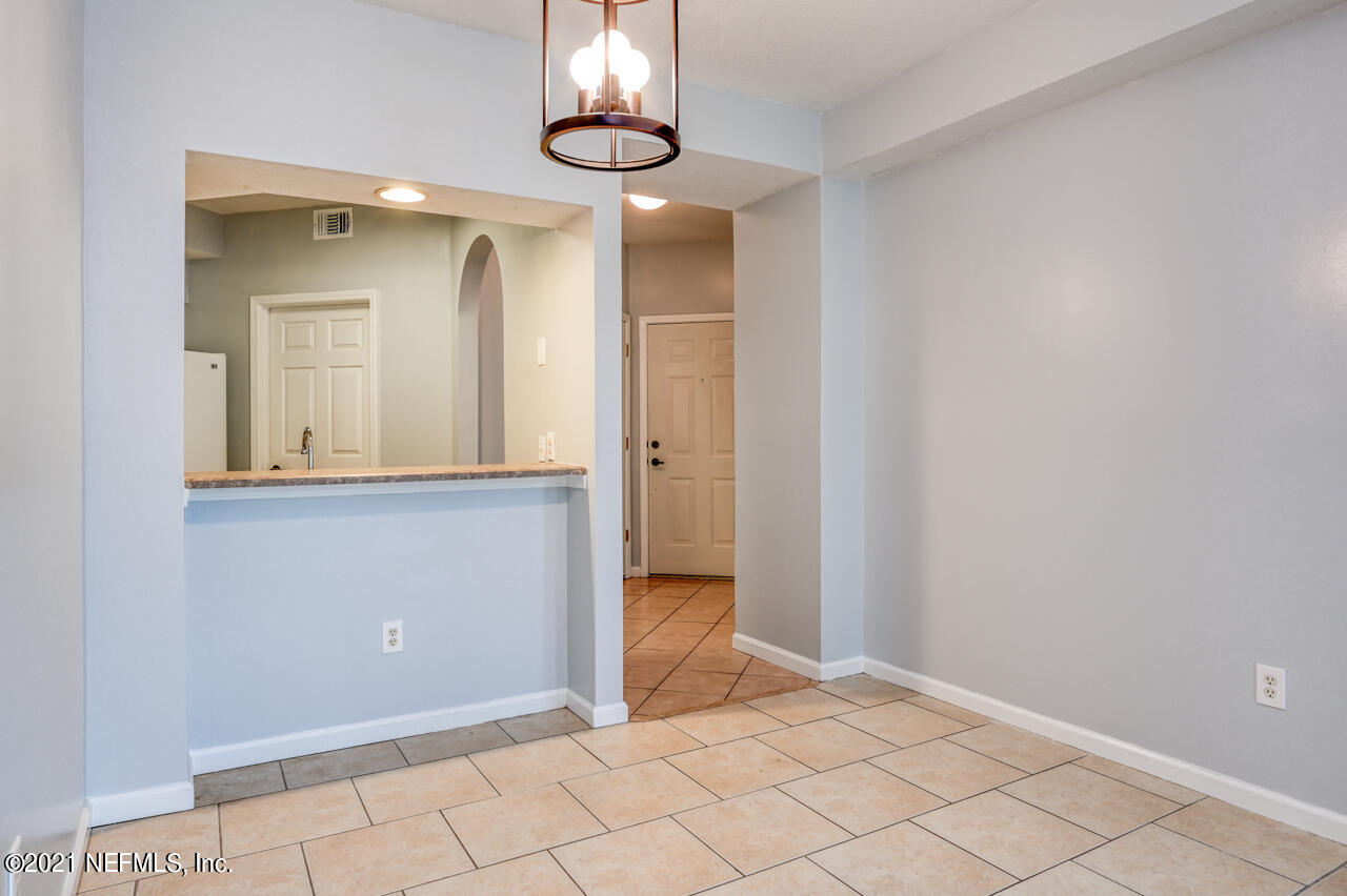 3400 Haley Pointe Road St. Augustine, FL 32084 - Photo 6 of 41 a view of a hallway with wooden floor and chandelier