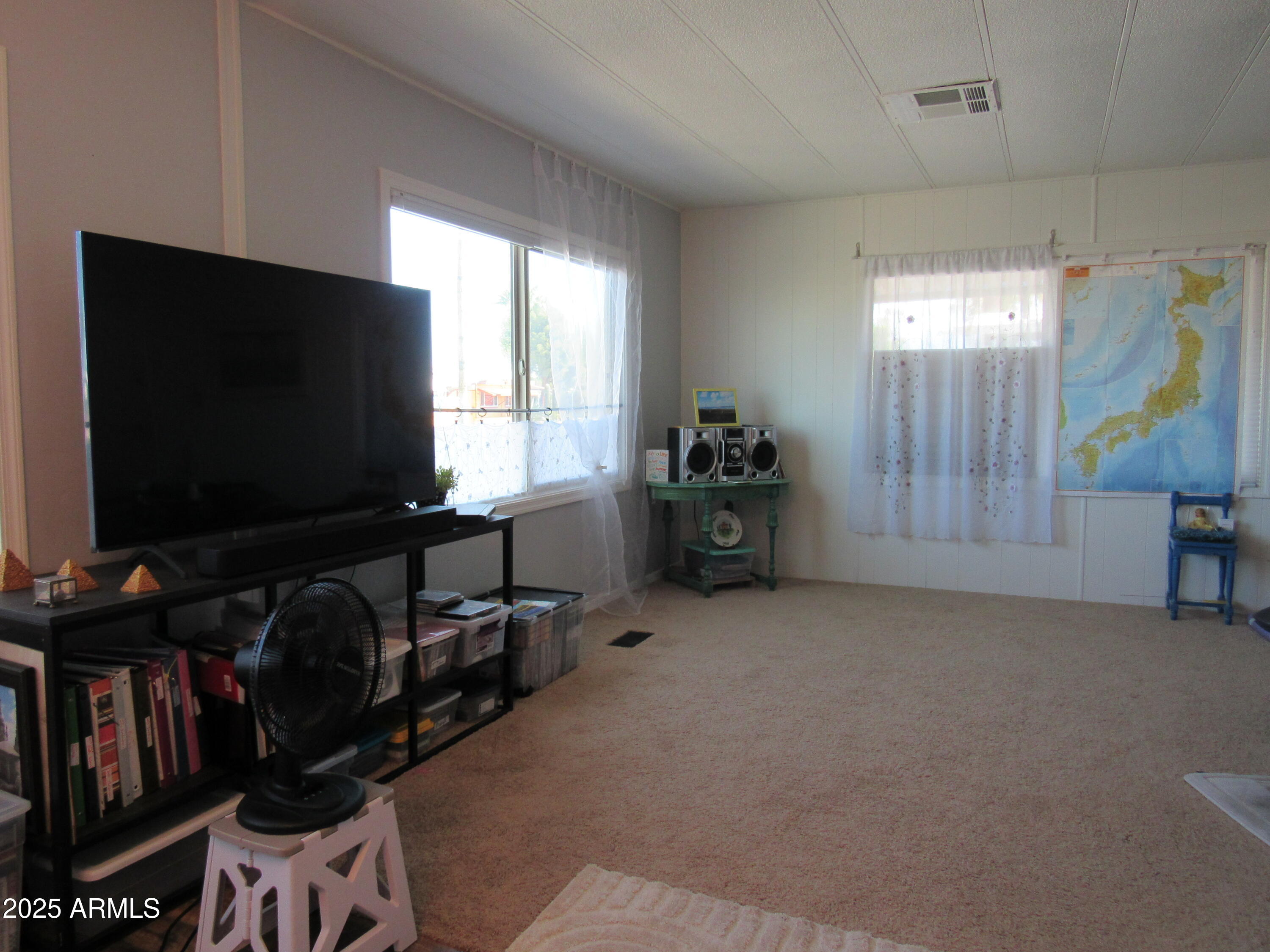 3411 South Camino Seco, Unit 213 Tucson, AZ 85730 - Photo 11 of 22 a living room with furniture and a flat screen tv