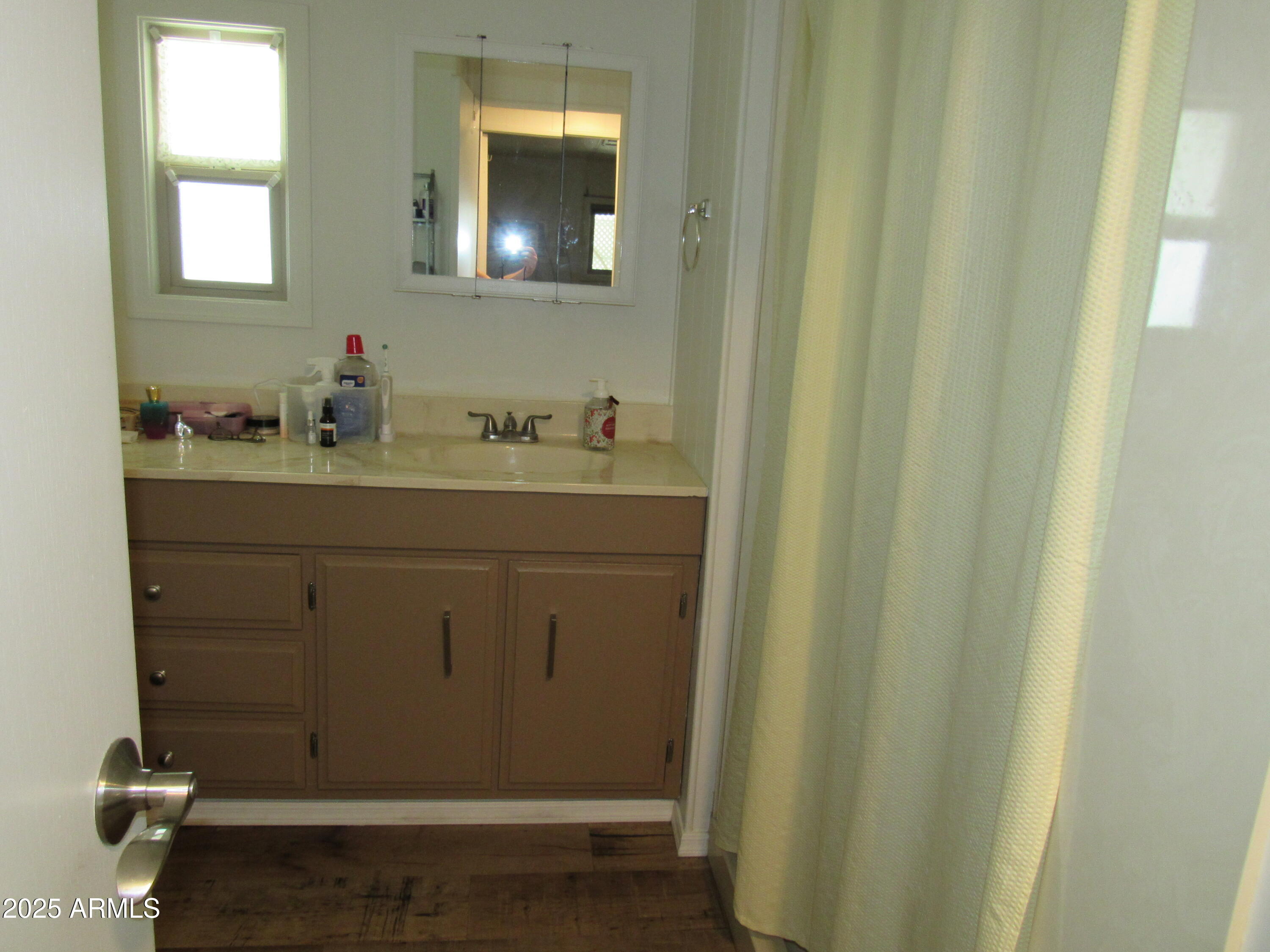 3411 South Camino Seco, Unit 213 Tucson, AZ 85730 - Photo 14 of 22 a bathroom with a sink a toilet and mirror