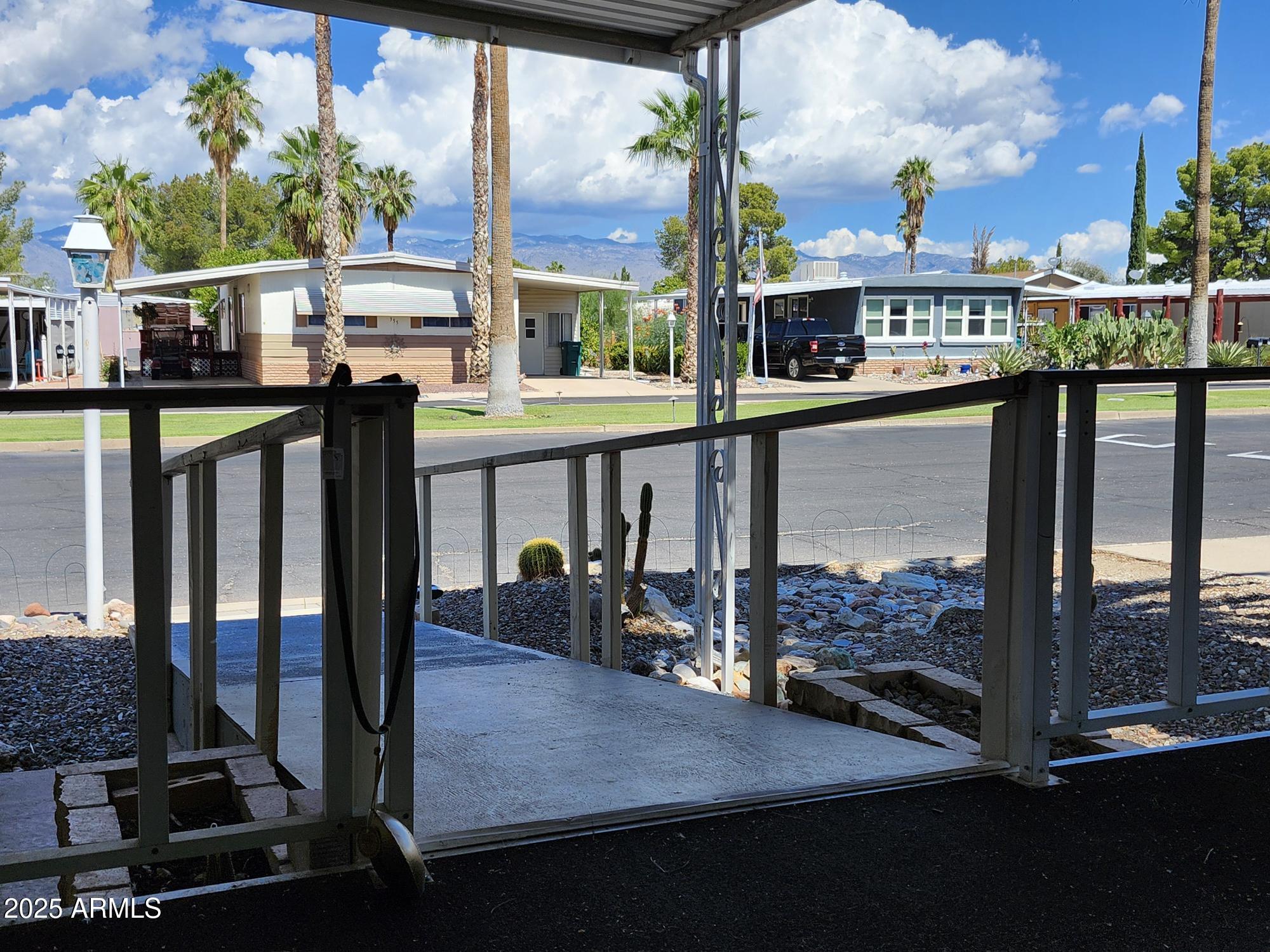 3411 South Camino Seco, Unit 213 Tucson, AZ 85730 - Photo 15 of 22 a view of a balcony with chairs