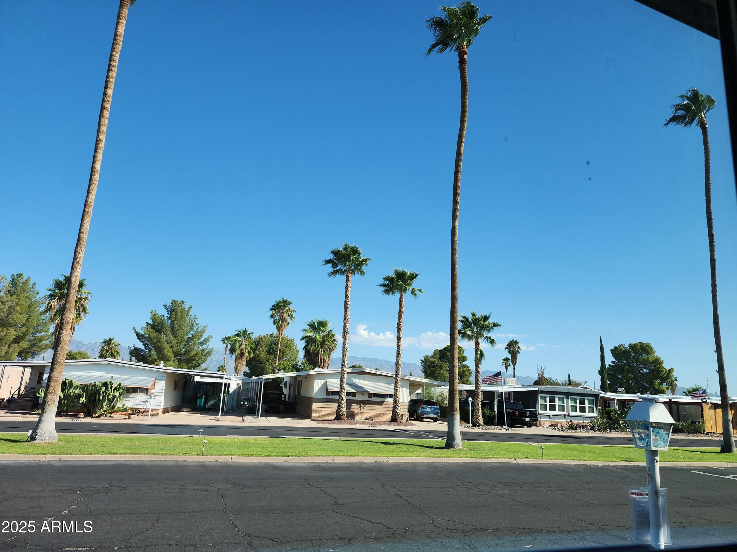 3411 South Camino Seco, Unit 213 Tucson, AZ 85730 - Photo 17 of 22 a view of a yard with cars parked