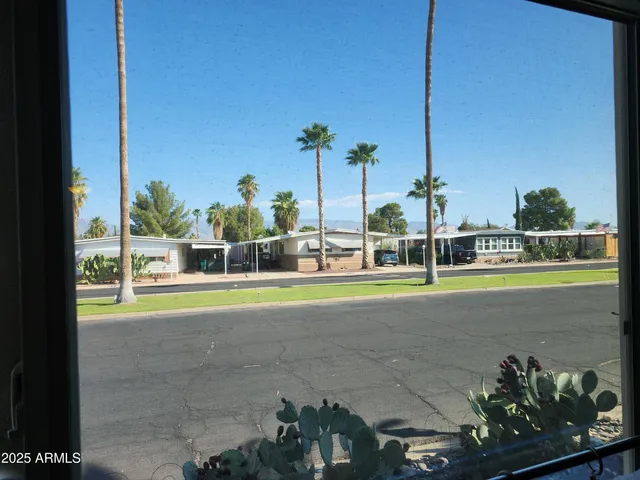 a view of a backyard house and swimming pool
