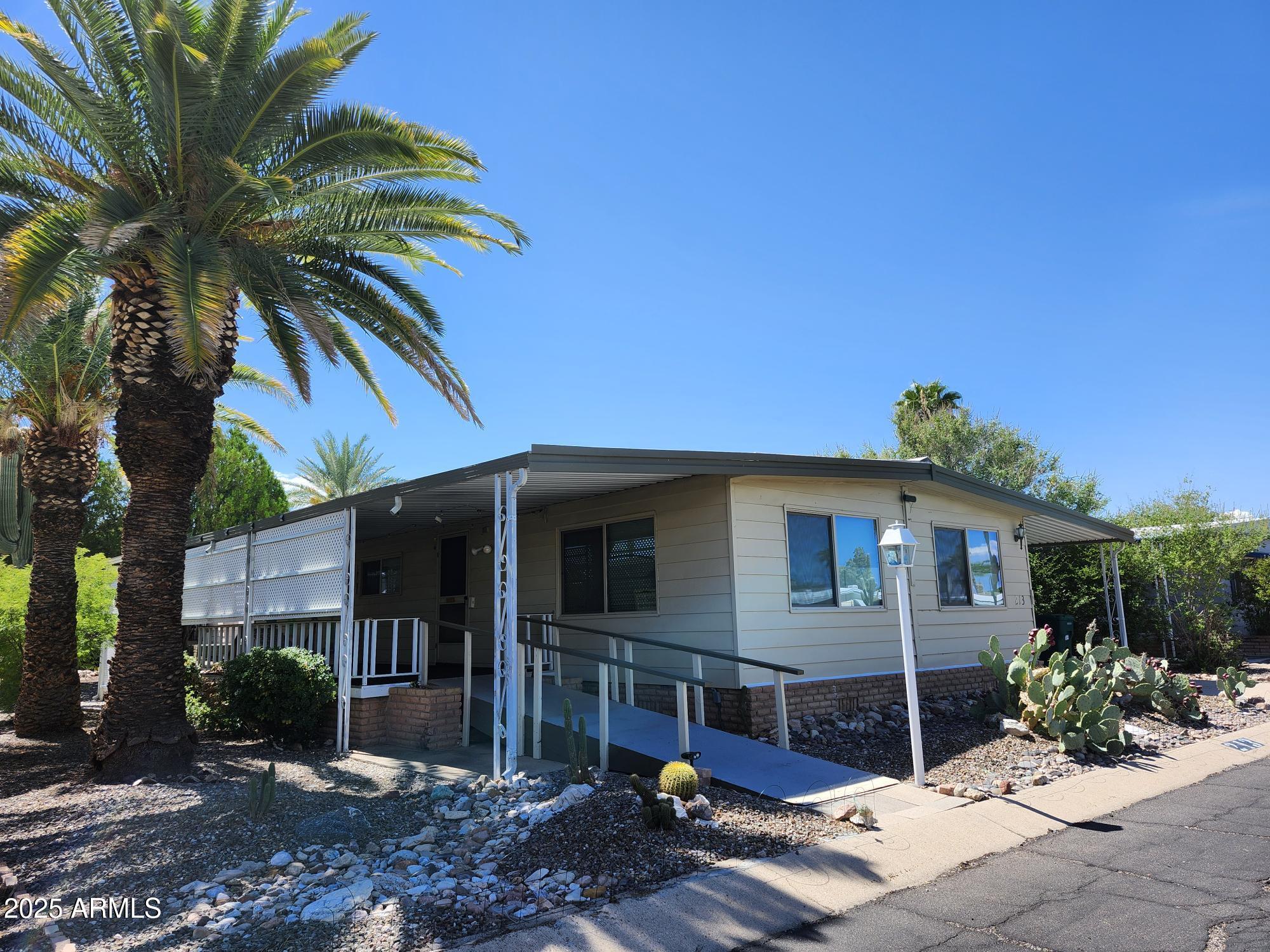 3411 South Camino Seco, Unit 213 Tucson, AZ 85730 - Photo 2 of 22 a view of a house with a patio