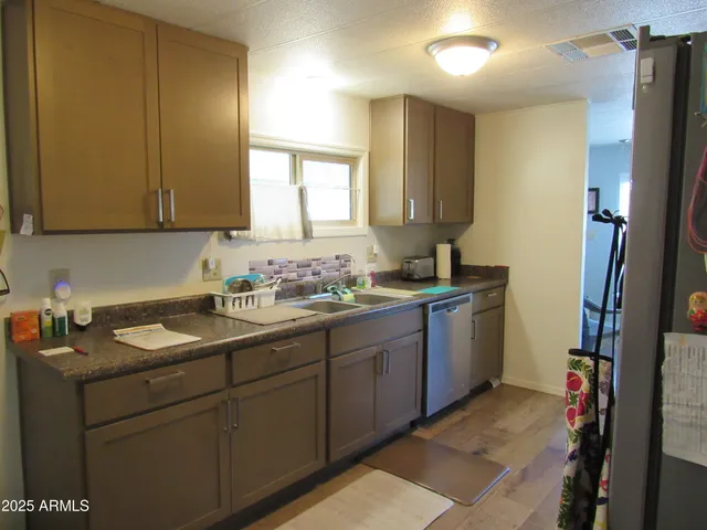 a kitchen with sink and cabinets