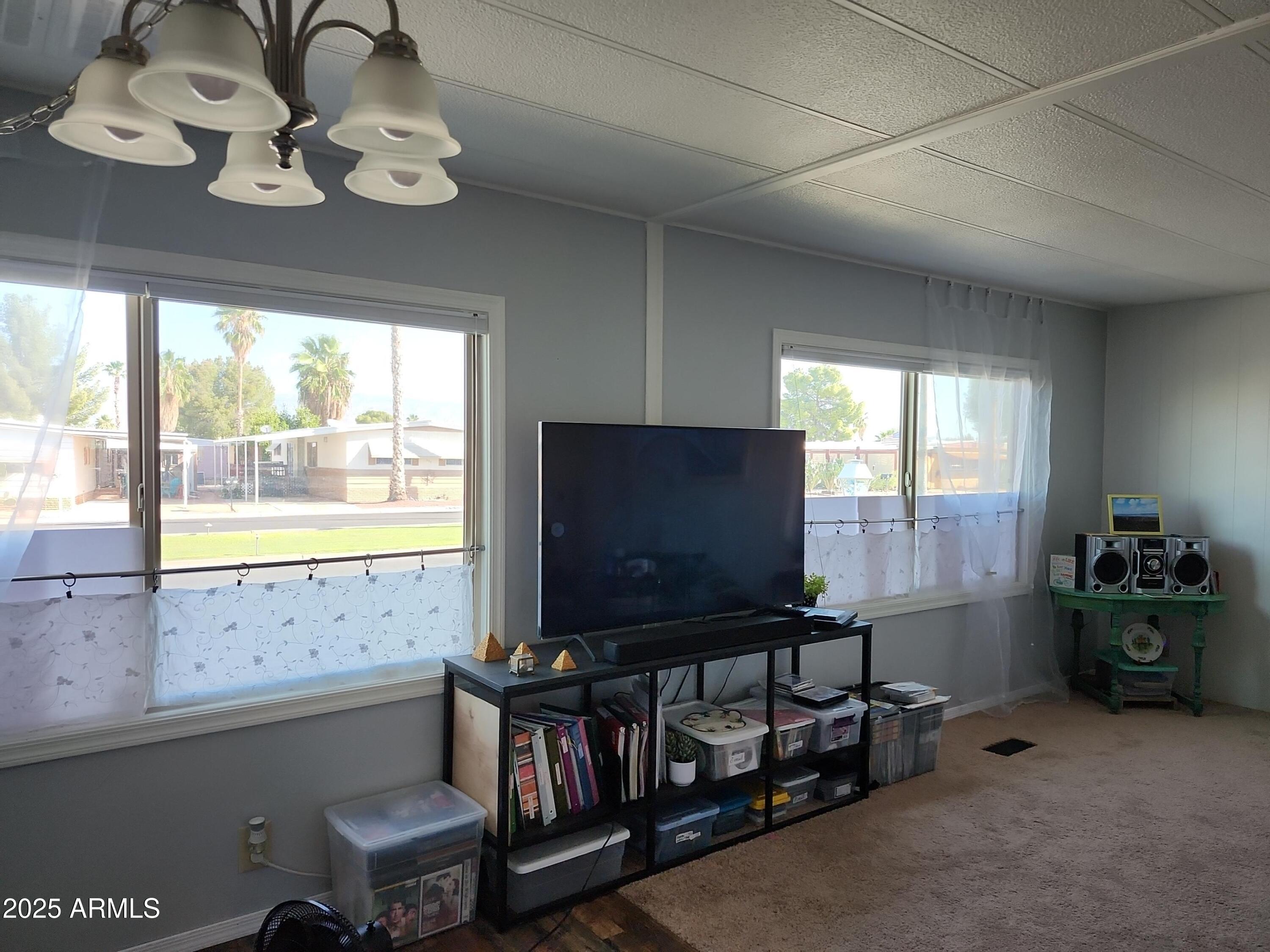 3411 South Camino Seco, Unit 213 Tucson, AZ 85730 - Photo 10 of 22 a room with furniture and window