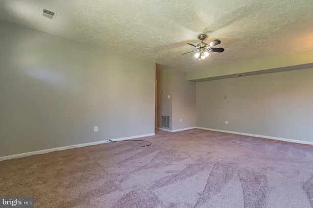 a view of an empty room with a fan