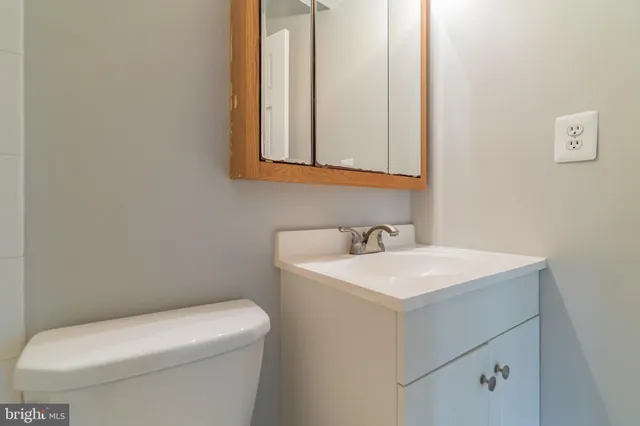 a bathroom with a toilet sink and mirror