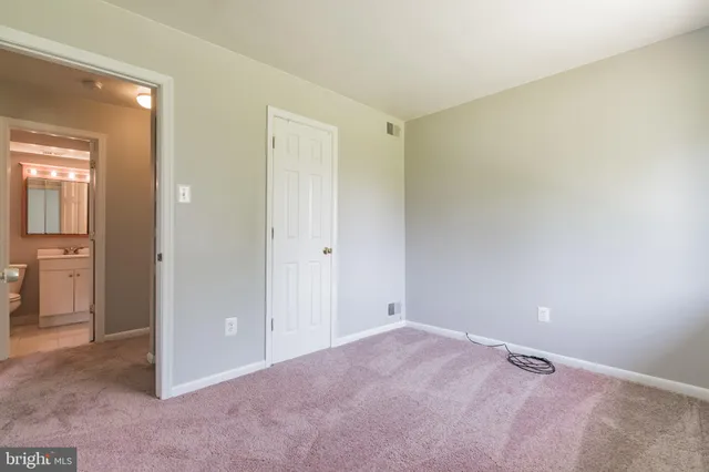 a view of a room with an empty space and wooden floor