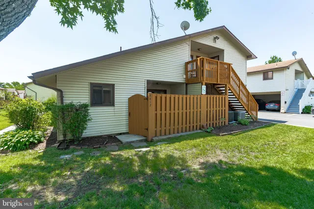 a view of a house with brick walls and a small yard