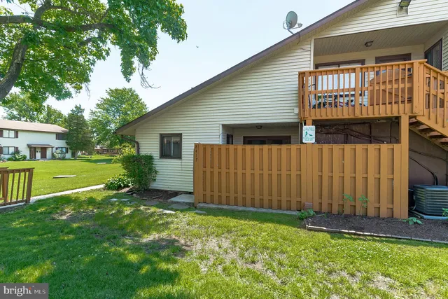 a view of backyard with a garden and deck