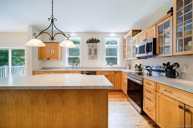 a view of a kitchen with a sink and wooden floor