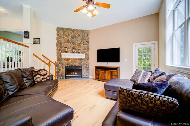 a living room with furniture a fireplace and a flat screen tv
