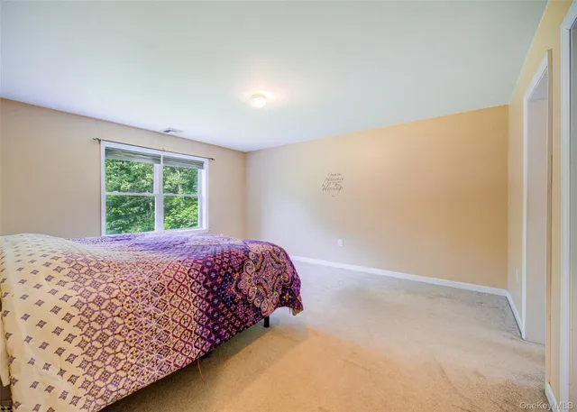 a bed sitting in a bedroom next to a window