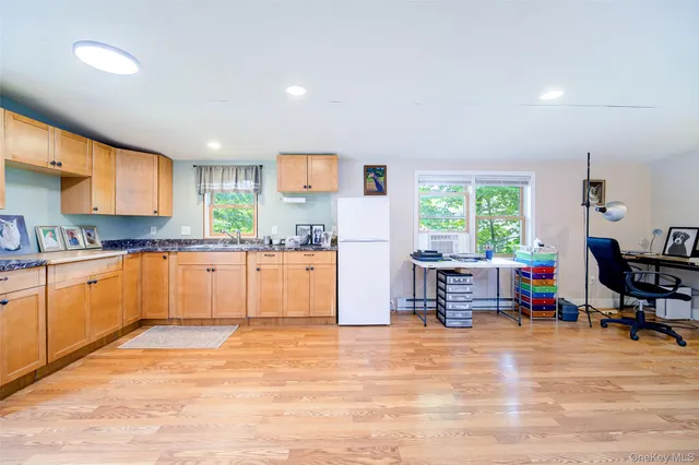 a view of a bedroom with a bed and a window