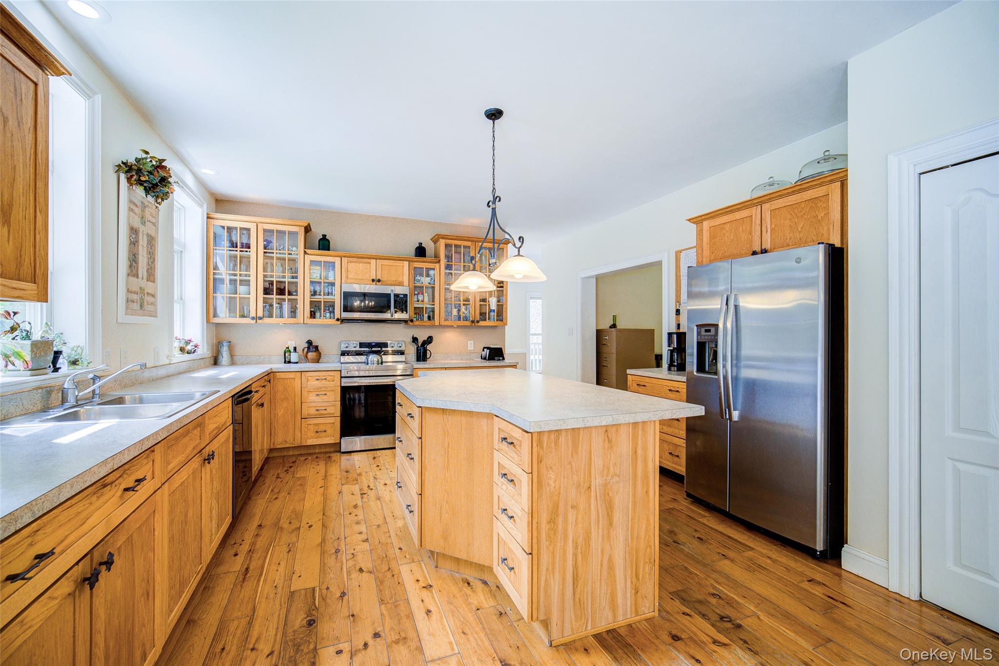 221 Rabbit Run Road Clintondale, NY 12515 - Photo 9 of 50 a kitchen with stainless steel appliances granite countertop a refrigerator a sink dishwasher a stove and a dining table with wooden floor