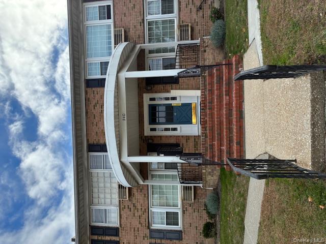 View of front facade featuring brick siding