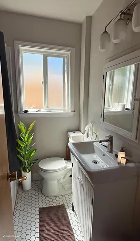a bathroom with a sink toilet and a mirror