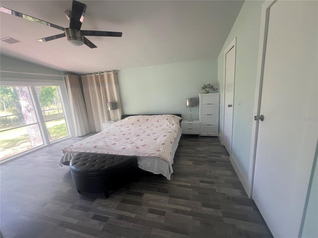 5855 Jack Brack Road St. Cloud, FL 34771 - Photo 77 of 86 a bedroom with a bed and a large window