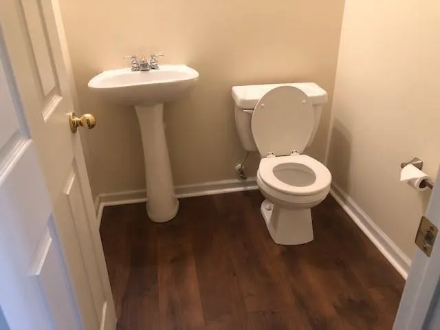 a bathroom with a toilet sink and mirror