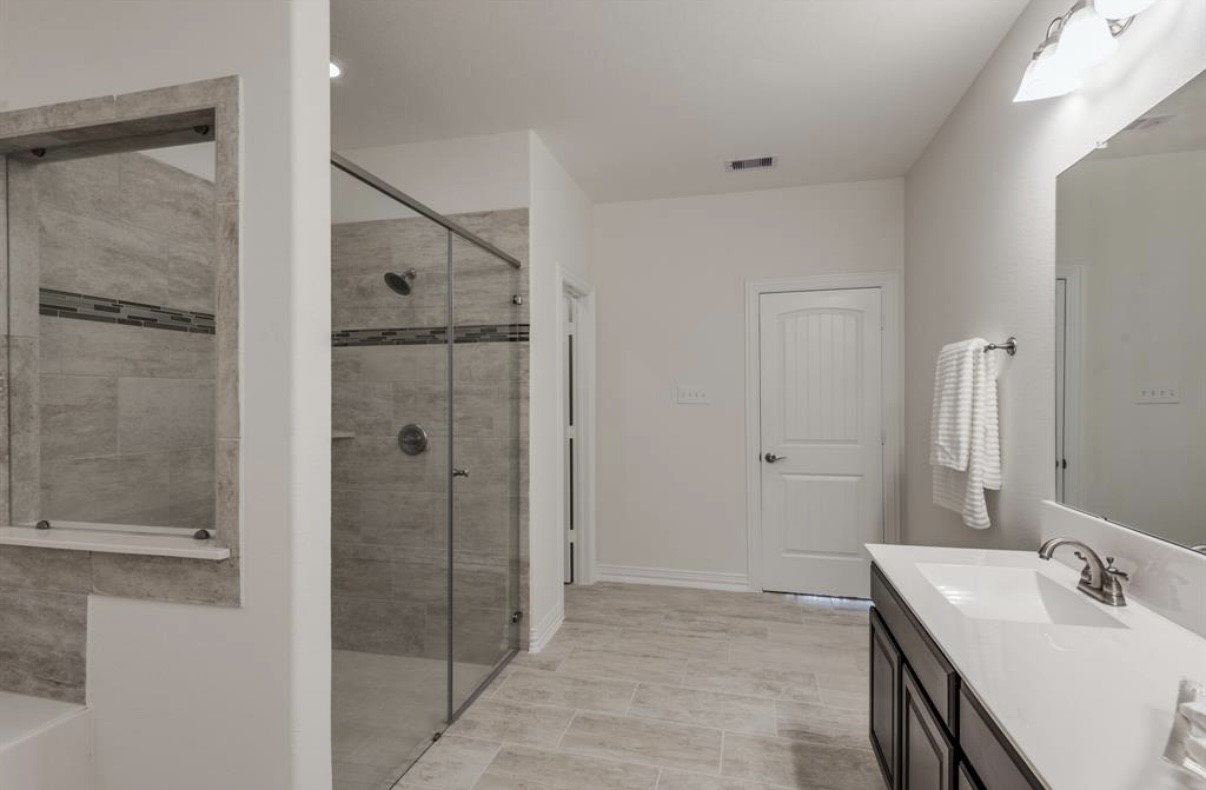 3223 Harmony Creek Lane Spring, TX 77386 - Photo 25 of 34 a bathroom with a shower sink and mirror