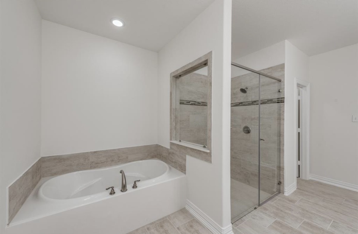 3223 Harmony Creek Lane Spring, TX 77386 - Photo 26 of 34 a bathroom with a bathtub and a shower