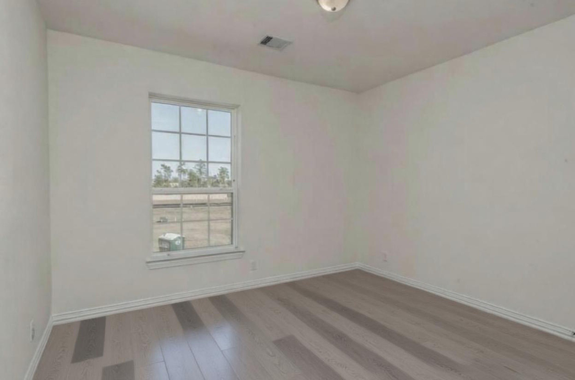 3223 Harmony Creek Lane Spring, TX 77386 - Photo 31 of 34 an empty room with wooden floor and windows